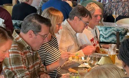 Guests sharing a meal at Uyare charity event