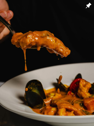Creamy seafood curry with mussels and shrimp served at Uyare restaurant