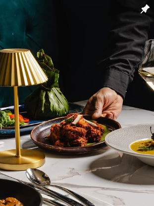 Uyare restaurant grilled chicken dish with elegant table setting and wine