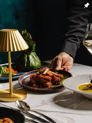 Uyare restaurant grilled chicken dish with elegant table setting and wine