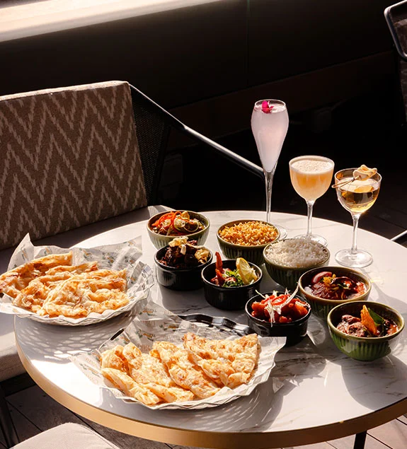 UYARE Sunday feast spread with mezze bowls, flatbread, and champagne cocktails