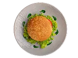 Uyare restaurant burger with fresh greens on sesame bun