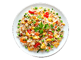Rice dish garnished with herbs and vegetables on a plate