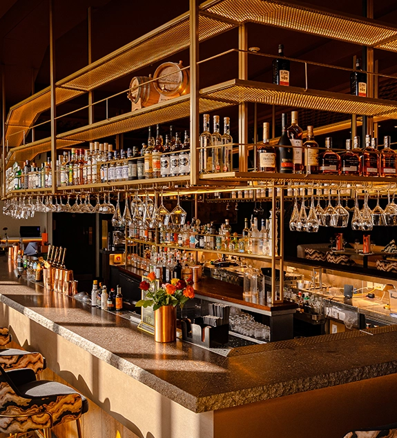 UYARE bar with fully stocked shelves and warm ambient lighting