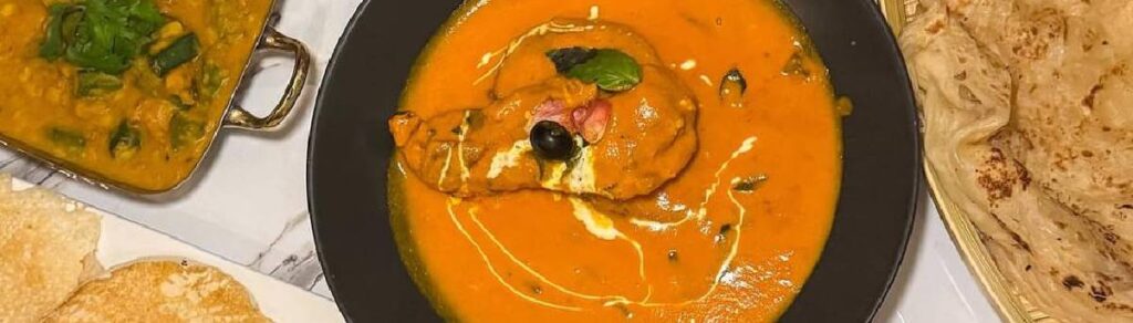 Uyare butter chicken curry served with naan and rice