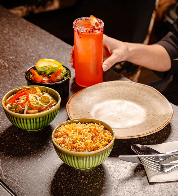 Pre-theatre menu at UYARE with mezze bowls, rice, and a citrus cocktail