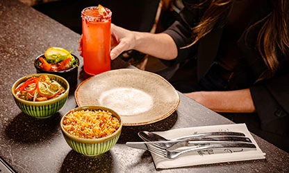 Pre-theatre dining table with mezze bowls and cocktail at UYARE