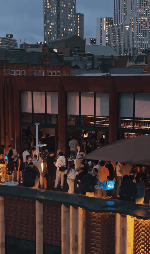 Guests celebrating with cocktails on Uyare rooftop bar Leeds