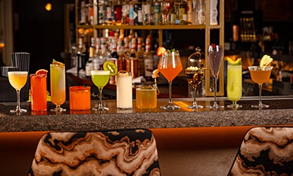 Colorful cocktails lined up on bar at UYARE Leeds for pre-theatre dining